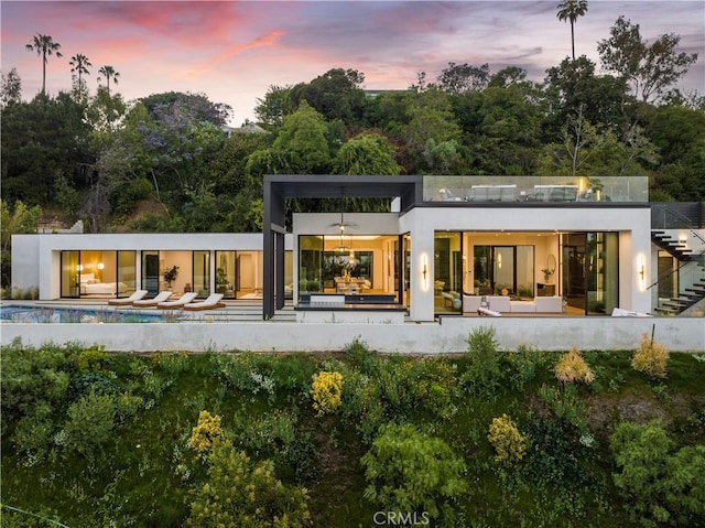 back house at dusk with a patio