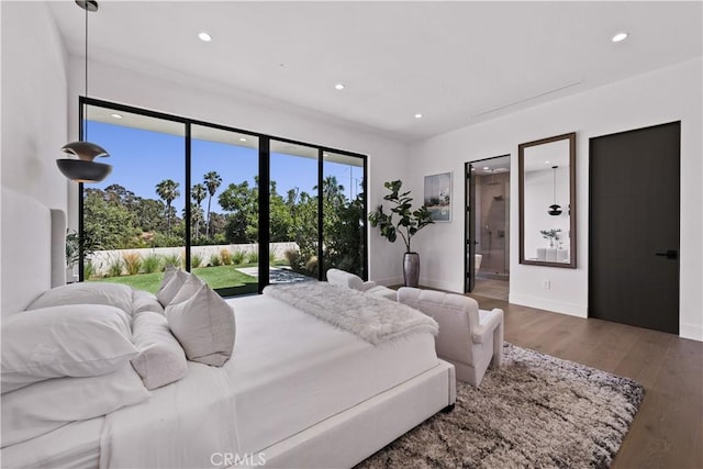 bedroom with wood-type flooring, ensuite bathroom, and access to outside