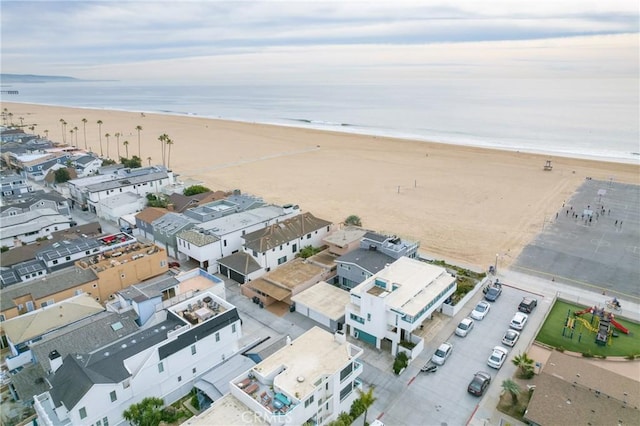 drone / aerial view with a water view and a beach view