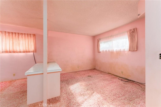 carpeted spare room featuring a textured ceiling