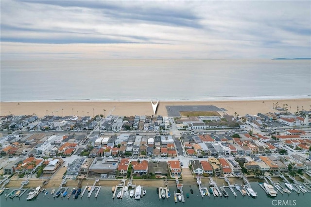 bird's eye view featuring a water view and a view of the beach