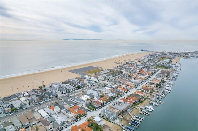 bird's eye view featuring a view of the beach and a water view