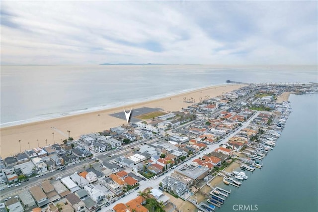 birds eye view of property featuring a water view and a view of the beach