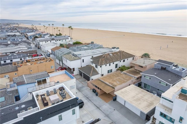 aerial view with a water view and a view of the beach