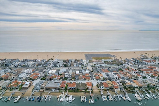 drone / aerial view featuring a view of the beach and a water view