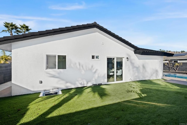 rear view of house featuring a lawn