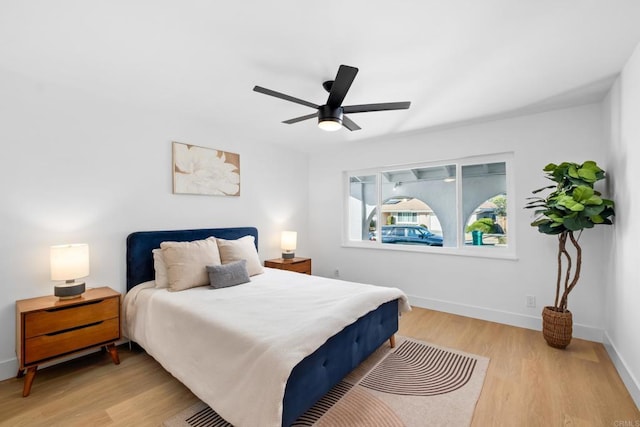 bedroom with ceiling fan and light hardwood / wood-style flooring