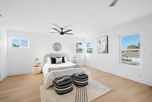 bedroom with ceiling fan and light wood-type flooring