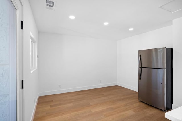 kitchen featuring light hardwood / wood-style flooring and stainless steel fridge