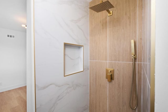 bathroom featuring wood-type flooring and walk in shower