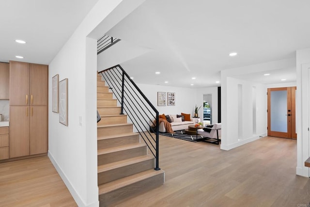 staircase with french doors and hardwood / wood-style floors