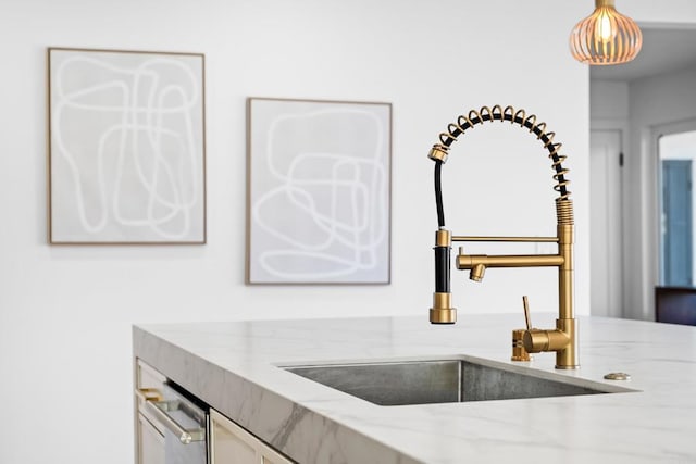 interior details with sink and light stone countertops