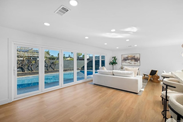 unfurnished living room with light wood-type flooring and a healthy amount of sunlight