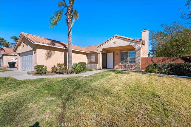 view of front of house featuring a garage and a front yard