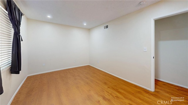 unfurnished room featuring hardwood / wood-style floors