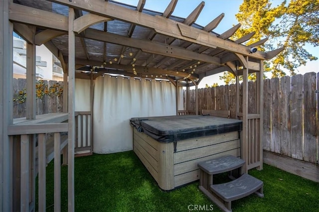 wooden deck with a hot tub and a pergola