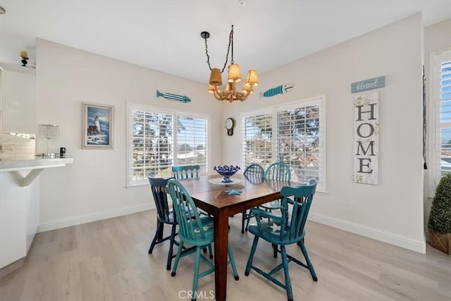 dining room featuring a chandelier and light wood-type flooring