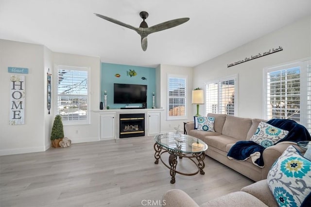 living room featuring ceiling fan and light wood-type flooring