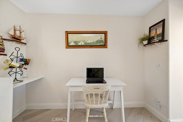 office area with light hardwood / wood-style floors