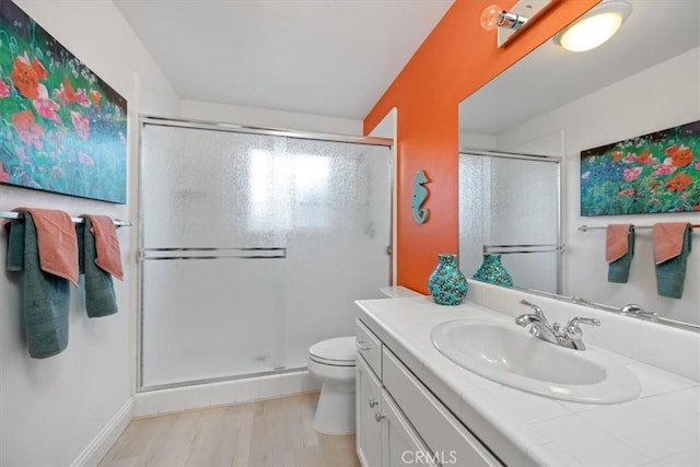 bathroom with vanity, hardwood / wood-style floors, toilet, and walk in shower