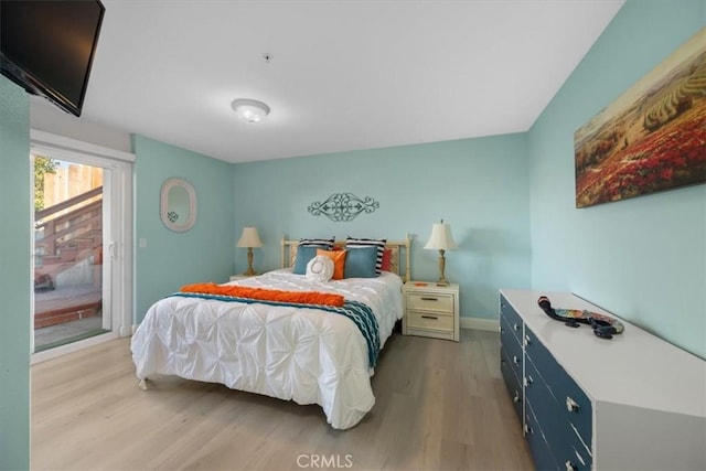 bedroom featuring access to outside and light hardwood / wood-style floors