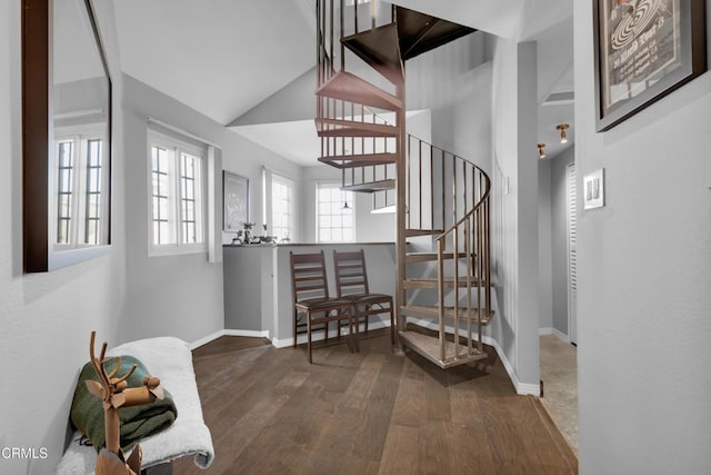 stairs featuring hardwood / wood-style flooring and vaulted ceiling