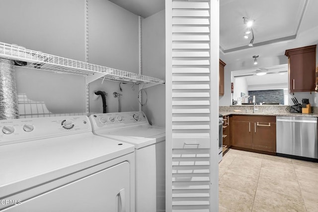 washroom featuring sink, washer and clothes dryer, and light tile patterned floors