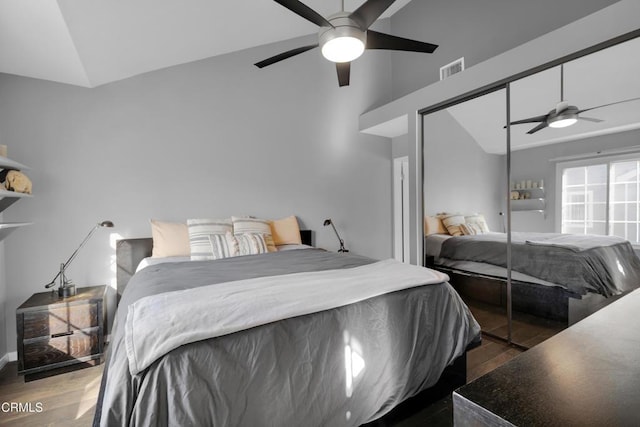 bedroom with lofted ceiling, ceiling fan, a closet, and dark hardwood / wood-style floors