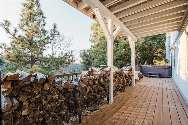 wooden deck with a hot tub