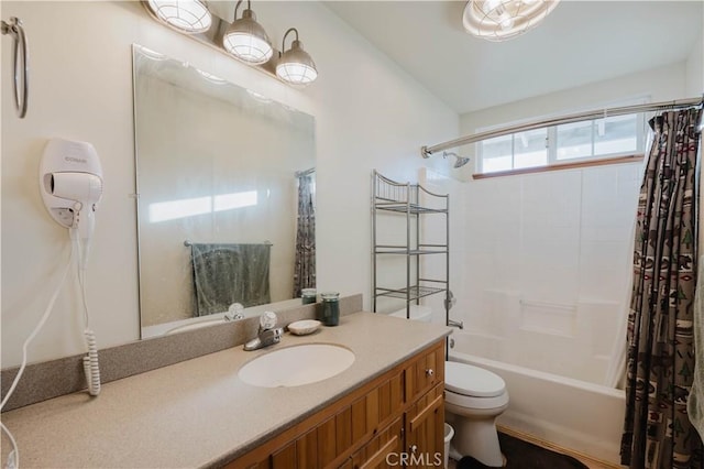 full bathroom featuring toilet, shower / bath combo with shower curtain, and vanity