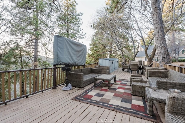 wooden deck with an outdoor hangout area and central air condition unit