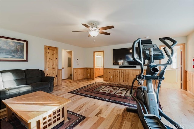 exercise room with light wood-type flooring and ceiling fan