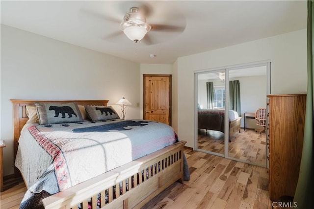 bedroom featuring ceiling fan, a closet, and light wood finished floors