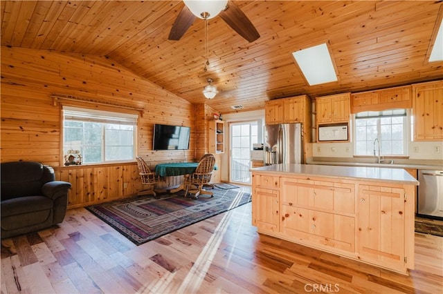 kitchen featuring stainless steel appliances, light wood-type flooring, wood walls, and wood ceiling