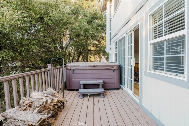 wooden deck with a hot tub