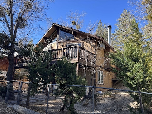 back of house with a wooden deck