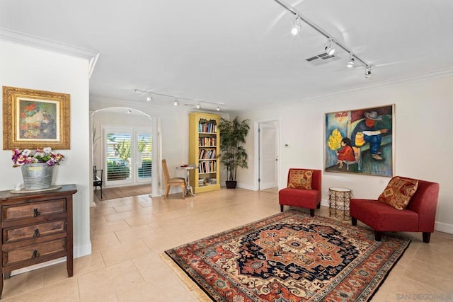 living area with ornamental molding and light tile patterned floors