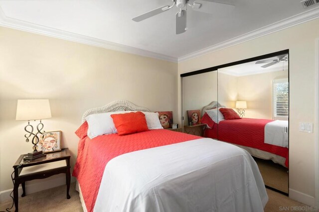 carpeted bedroom with ceiling fan and ornamental molding