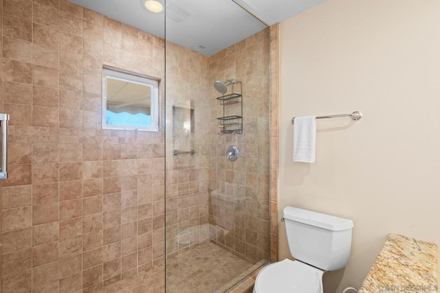 bathroom featuring toilet and tiled shower