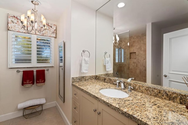 bathroom with walk in shower, vanity, tile patterned flooring, and a chandelier