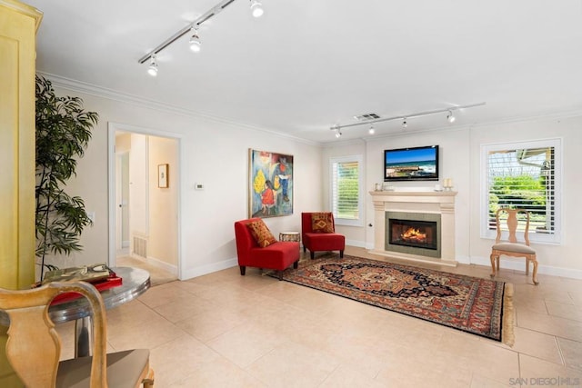 sitting room featuring ornamental molding and light tile patterned floors