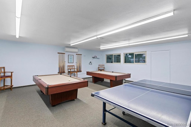 rec room with pool table, a textured ceiling, and a wall unit AC