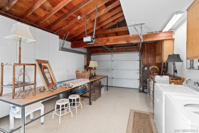 garage featuring independent washer and dryer and a garage door opener