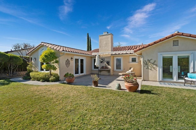 rear view of house featuring a pergola, a patio, french doors, and a yard