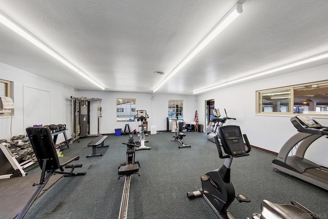 workout area featuring a textured ceiling