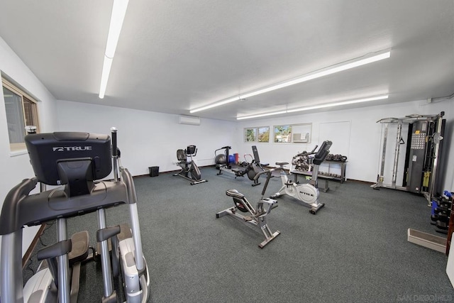 workout area featuring a wall mounted air conditioner