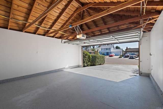 garage featuring wooden ceiling and a garage door opener