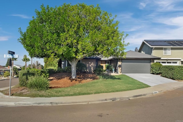 obstructed view of property featuring a front yard and a garage