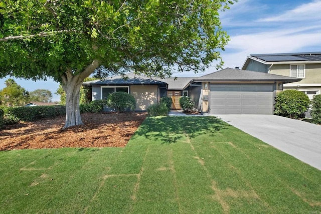 view of front of property with a front yard and a garage