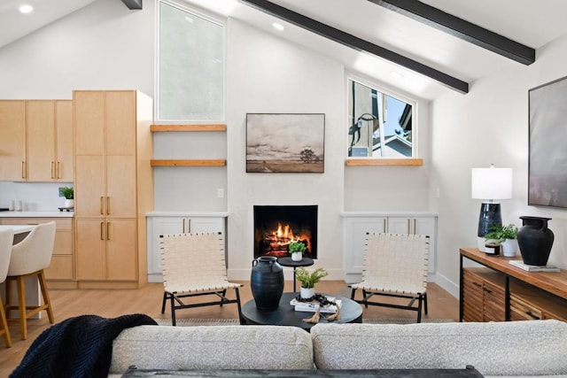 living room featuring high vaulted ceiling, light wood-type flooring, and beam ceiling